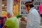 CHICHEN ITZA, MEXICO - NOVEMBER 12, 2017: Close up of Indian chaman using plants to cure an old woman inside of a store