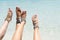 Chick vacation vibe concept. Woman legs with leg jewellery on the tropical white sand beach