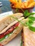 Chicken bacon lettuce and tomato sandwich in ciabatta bread with golden chips