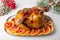 Chicken baked whole to appetizing crispy crust with pomegranate and red orange. Traditional New Year and Christmas dish.