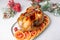 Chicken baked whole to appetizing crispy crust with pomegranate and red orange. Traditional New Year and Christmas dish.