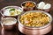 Chicken biryani with traditional sides