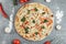 Chicken-blue pizza with tomato, mozzarella and Dor Blue cheeses on gray background