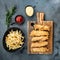 Chicken breaded fillet on grey background, top view