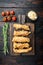 Chicken breaded fillet on old dark wooden table, flat lay