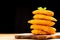 Chicken breaded nuggets with basil leaves on a wooden kitchen board on a wooden table on a black background. Fast homemade food.