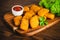 Chicken Breaded Raw Meat.Semifinished Breaded chicken nuggets from chicken fillet on a dark background with fresh herbs