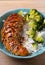 Chicken breast in balsamic vinegar and brown sugar sauce sprinkled with sesame seeds. Chicken with rice and broccoli.