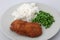 Chicken breast breaded with white rice and green peas side