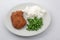 Chicken breast breaded with white rice and green peas side