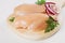 Chicken breast meat on wooden board