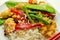 Chicken breast pieces in a Thai red curry sauce made with coconut cream, red chillies, lemongrass, lime leaf, with fragrant rice,