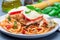 Chicken caprese with tomato and mozzarella cheese, served with linguine, tomato pasta sauce and basil, horizontal, closeup