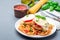 Chicken caprese with tomato and mozzarella cheese, served with linguine, tomato pasta sauce and basil, horizontal, copy space