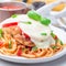 Chicken caprese with tomato and mozzarella cheese, served with linguine, tomato pasta sauce and basil, square, closeup