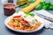 Chicken caprese with tomato and mozzarella cheese, served with linguine, tomato sauce and basil, horizontal