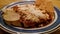 Chicken and cheese enchiladas. Typical Mexican dish with totopos and potatoes.