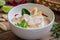 Chicken with coconut milk soup in bowl, Thai food Tom Kha Kai