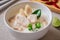 Chicken with coconut milk soup in bowl, Thai food Tom Kha Kai