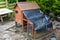 Chicken coup with concrete base and improvised waterproof cover