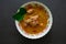 Chicken curry or kari ayam served on bowl, isolated on white background.