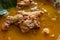 Chicken curry or kari ayam served on bowl, isolated on white background.