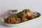 Chicken curry prepared by chicken in cashew gravy garnished with fresh coriander leaves