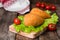 Chicken cutlets in breadcrumbs - Chicken Kiev on wood board and wooden background. Ukrainian cuisine. Selective focus