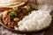 Chicken Do Pyaaza cooked in a variety of spices, yogurt and kasoori methi served with rice and flatbread. horizontal