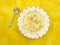 Chicken dumpling soup on yellow tablecloth