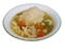 Chicken and dumplings in a white bowl with green rim