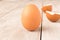 Chicken egg and eggshell on wooden table. Selective focus