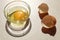 Chicken egg in a glass dish on the background of eggshells on the kitchen table