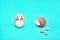 Chicken egg in a medical face mask. next broken shell. concept. blue background