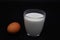 Chicken egg and yogurt in a glass glass, correct and healthy nutrition, dark background