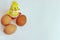 Chicken eggs are brown next to a toy yellow chicken. Happy Easter. Copy space.