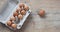 Chicken eggs in carton on wooden table. Eggs Yolk Cooking Top View