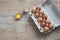 Chicken eggs in carton on wooden table. Eggs Yolk Cooking Top View