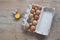 Chicken eggs in carton on wooden table. Eggs Yolk Cooking Top View