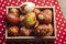 Chicken eggs colored with old-fashioned natural method by onion husks. Brown eggs with different natural patterns in box on red.