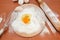 Chicken eggs, flour, whisk and rocking chair on the table. The process of making dough. Broken egg in flour on a wooden board. Vie