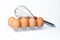 chicken eggs and manual mixer on white background