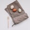 Chicken eggs of natural shades and colors and wooden fork, bamboo cutlery on white background. Healthy organic food, natural