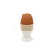 Chicken eggs placed in ceramic cups on white background