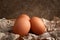 Chicken eggs. Raw brown chicken eggs on crumpled wrapping paper on a dark background. High calorie protein food concept