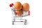 Chicken eggs in the shopping cart, white isolated background. Healthy food