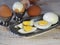 Chicken eggs on a wooden rustic white table. Purified and unpeeled. Shells. Preparing a filling for pies. Homemade food