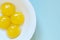 Chicken eggs yolks in the white bowl on the blue background.