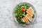 Chicken fillet salad with fresh vegetables and arugula. Fresh vegetable salad of arugula, tomatoes, onion and grilled chicken