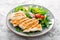 Chicken fillet salad with fresh vegetables and arugula. Fresh vegetable salad of arugula, tomatoes, onion and grilled chicken